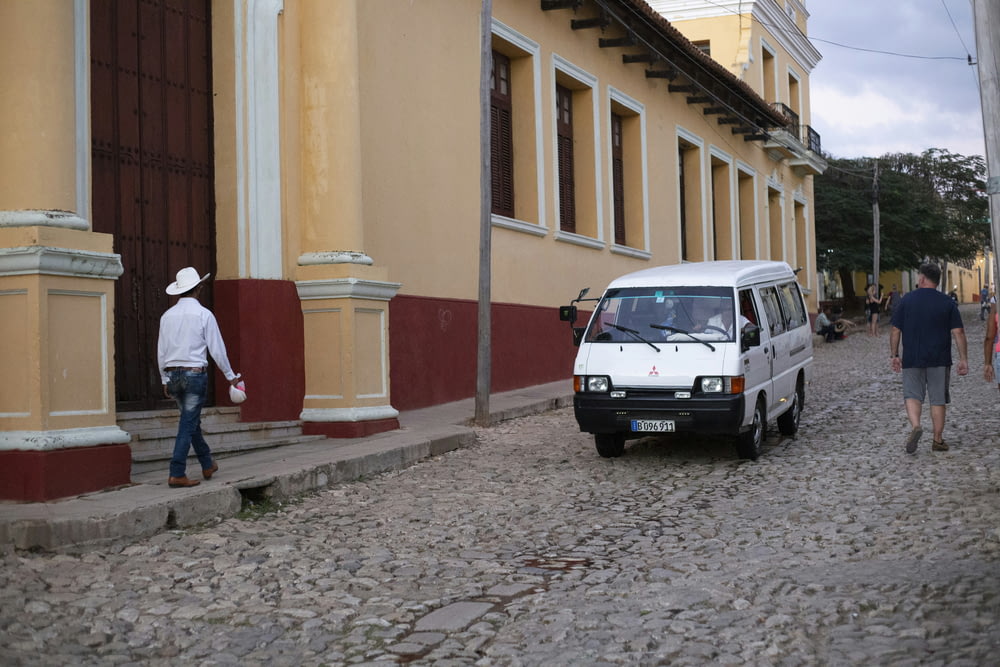a van is parked on a cobblestone street