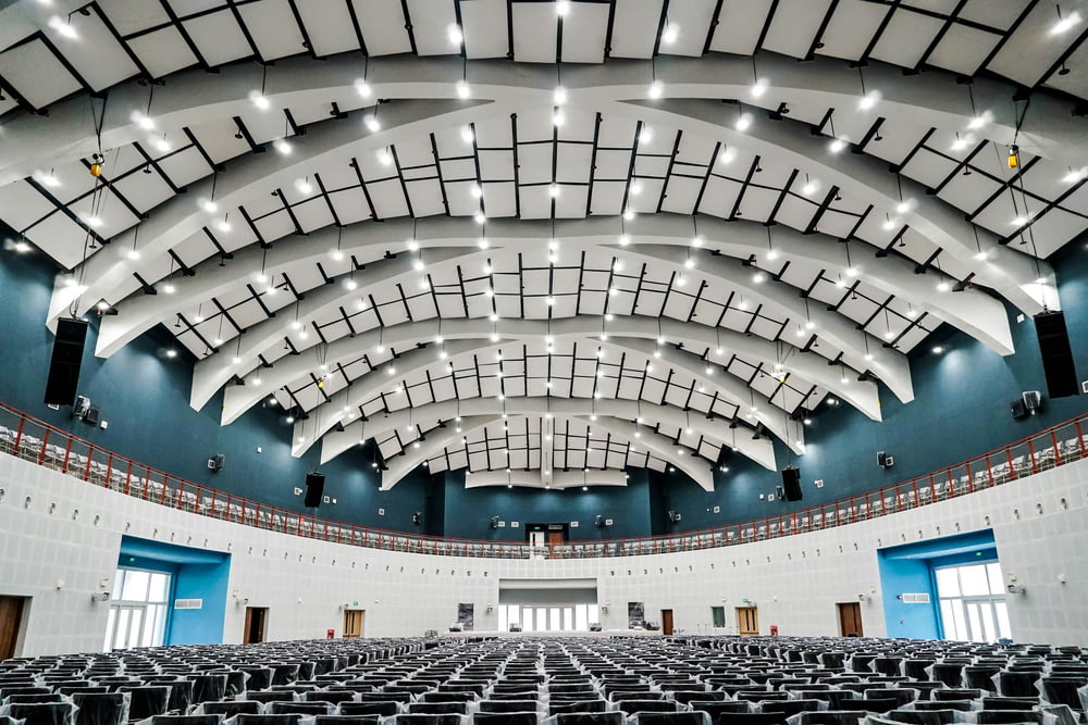 a large auditorium with rows of seats and a ceiling