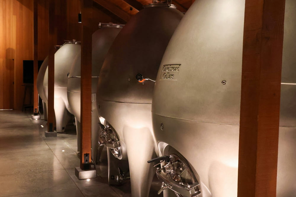 a row of silver tanks sitting next to each other