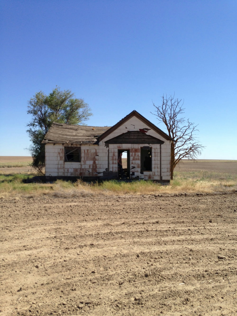 an old run down house in the middle of nowhere