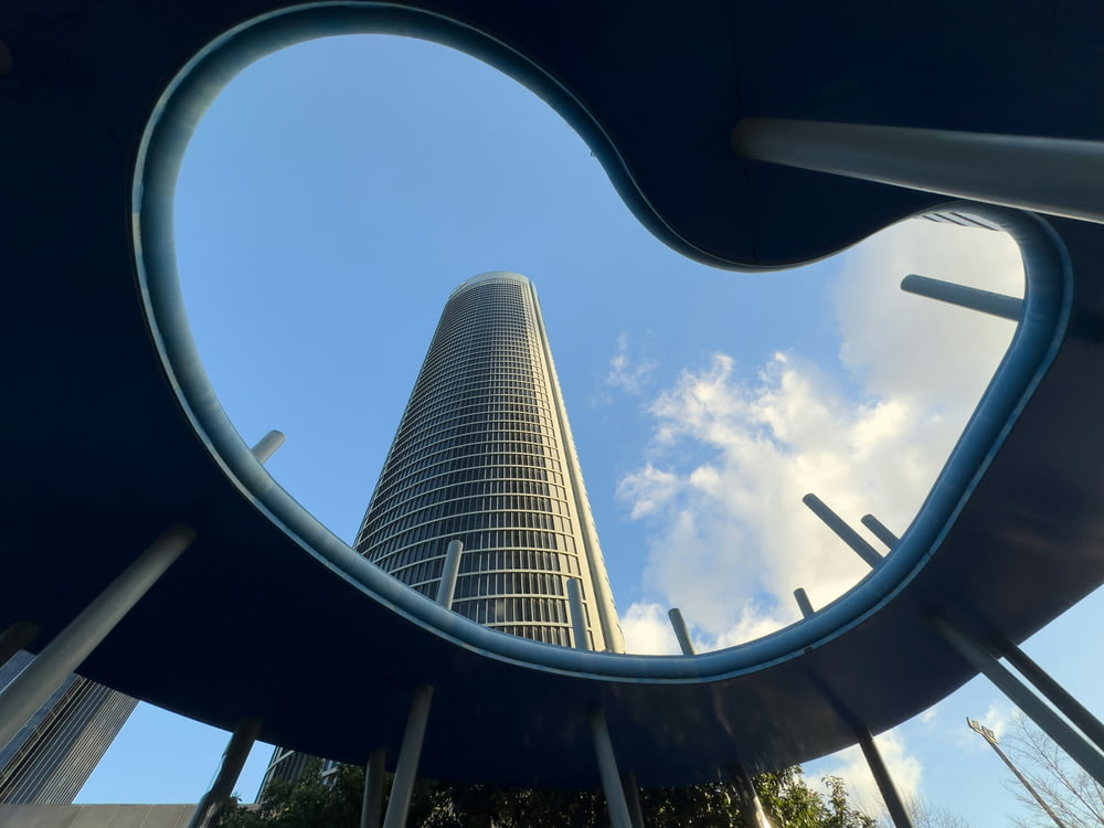a tall building seen through a circular window