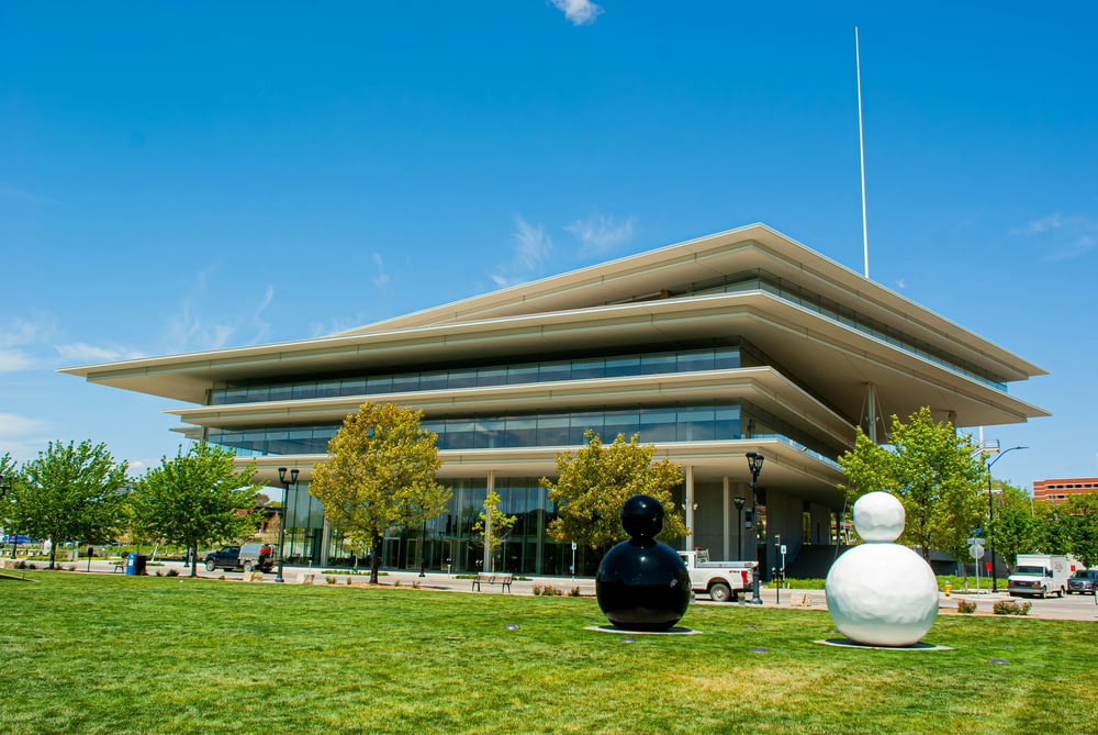 a large building with two sculptures in front of it