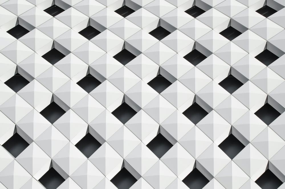 a white wall with black squares on it