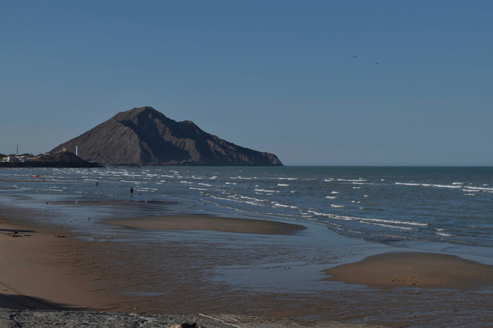 a beach with a mountain in the background