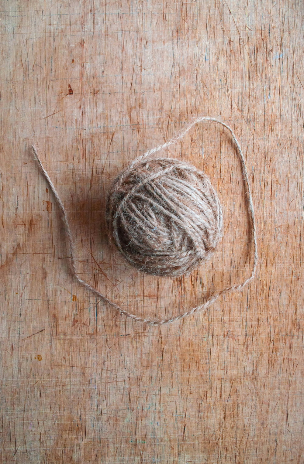 a ball of yarn sitting on top of a wooden table