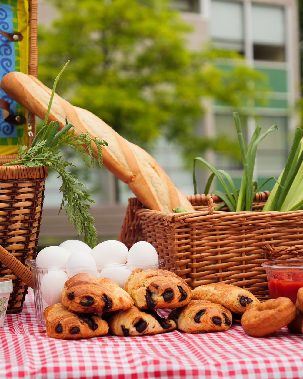 a table topped with pastries next to a basket of bread