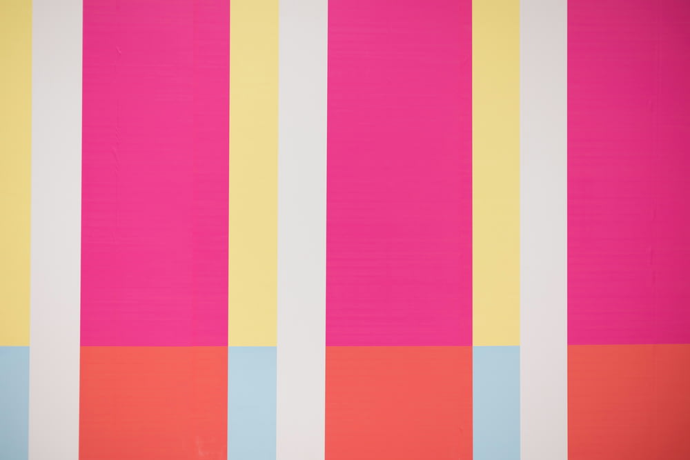 a pink, yellow, and blue striped wallpaper