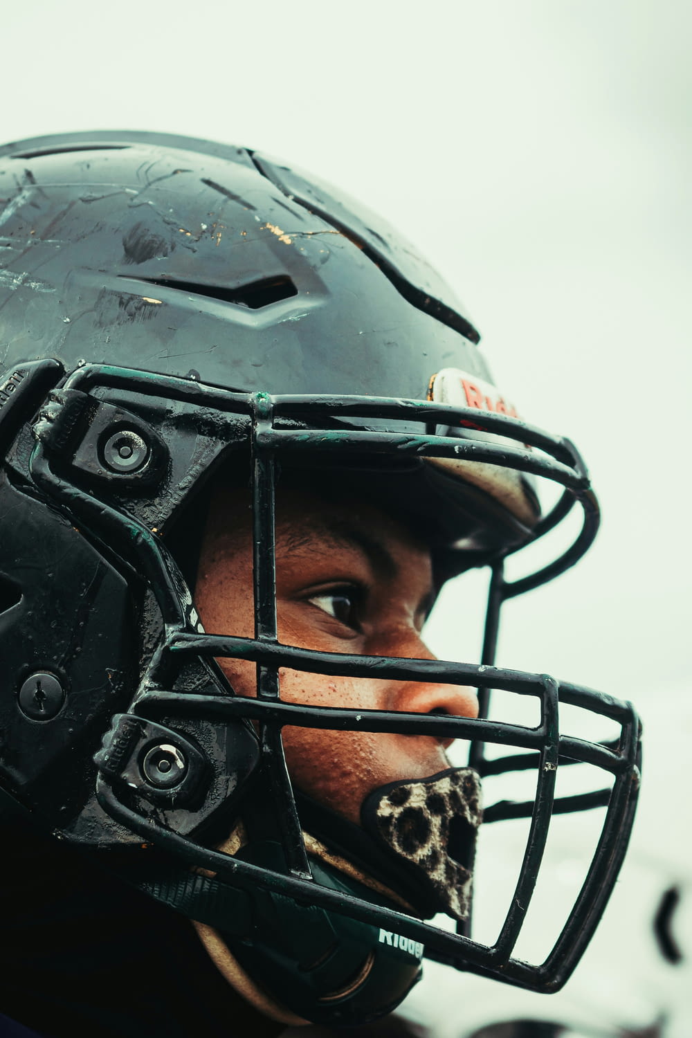 a close up of a person wearing a football helmet