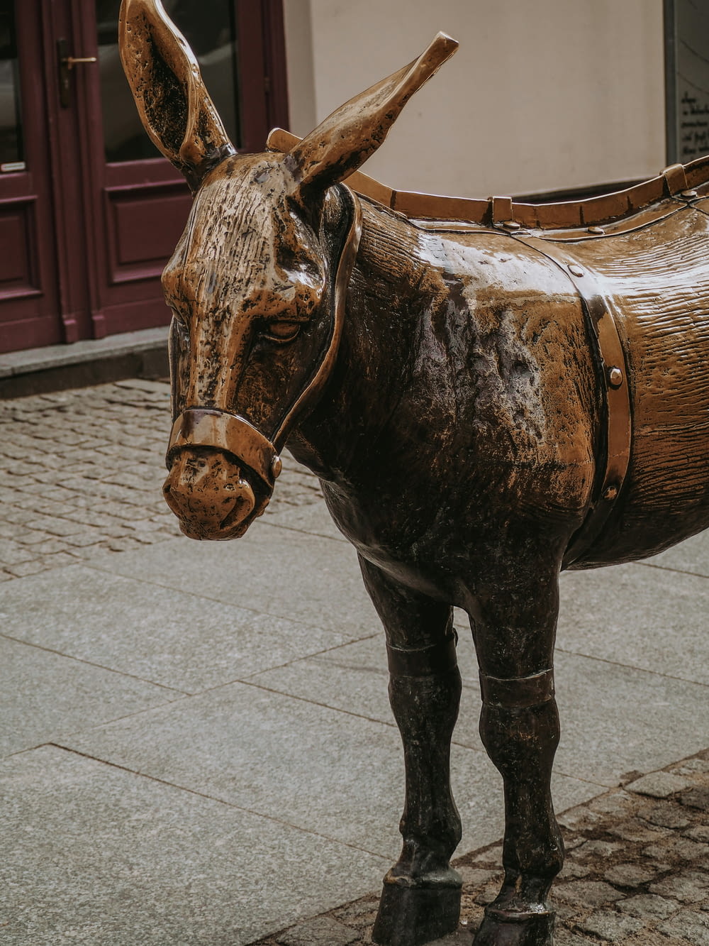 a statue of a donkey on a sidewalk