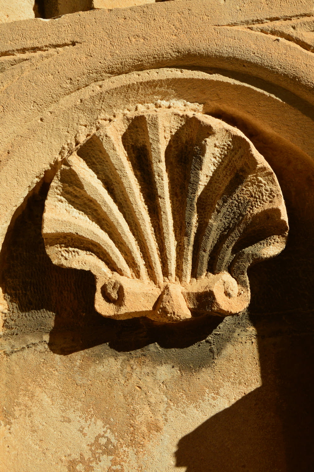 a close up of a decorative object on the side of a building