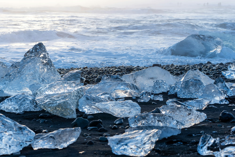 a bunch of ice cubes sitting on top of a beach