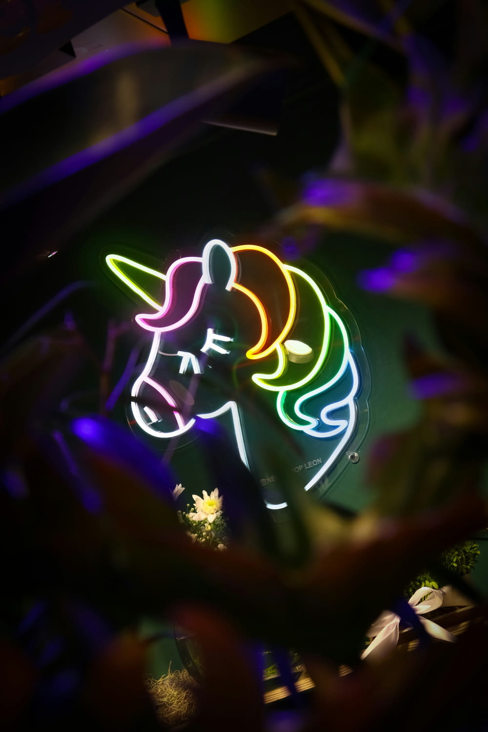 a close up of a neon sign with a unicorn on it
