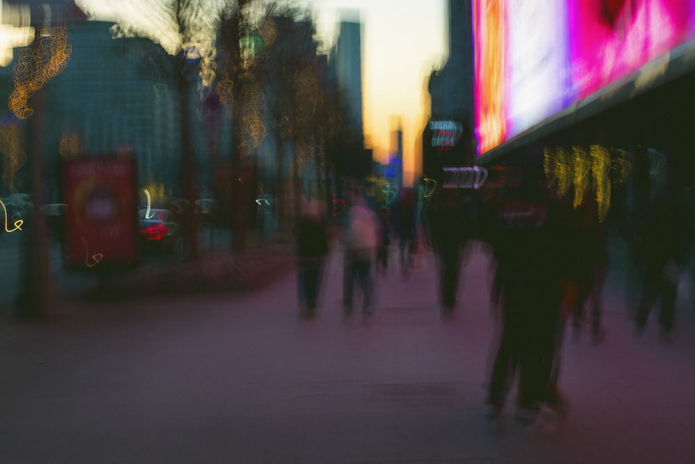 a blurry photo of people walking down a street