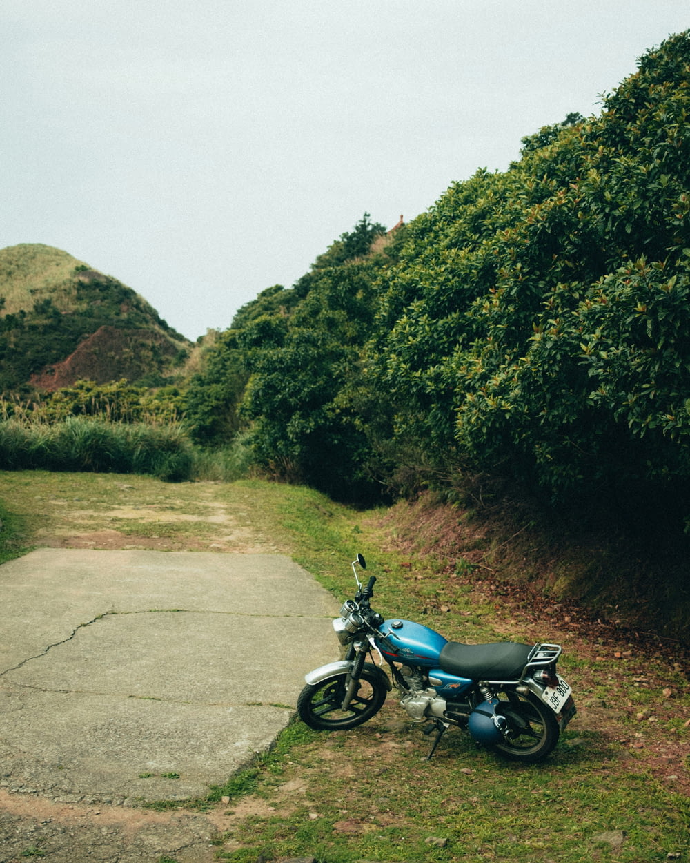 a blue motorcycle parked on the side of a road
