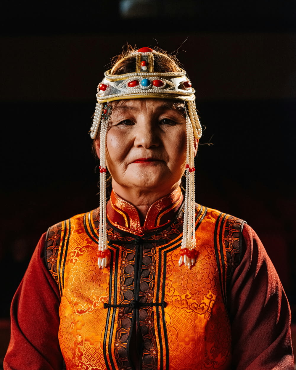 an old woman wearing a headdress and a necklace
