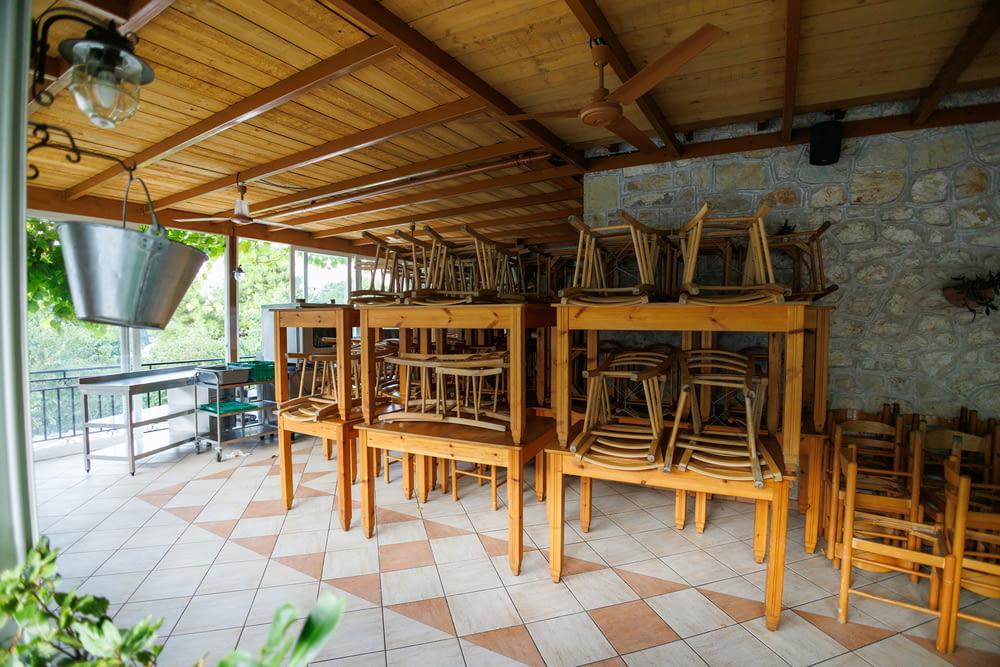a number of wooden chairs near one another