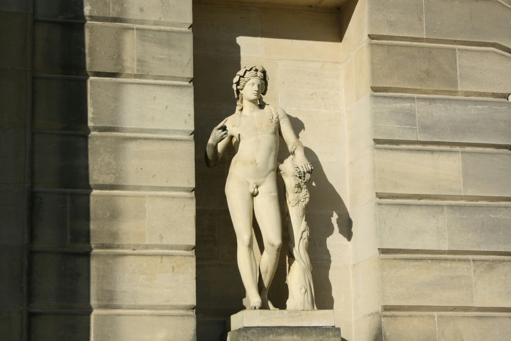 a statue of a woman and a dog on the outside of a building