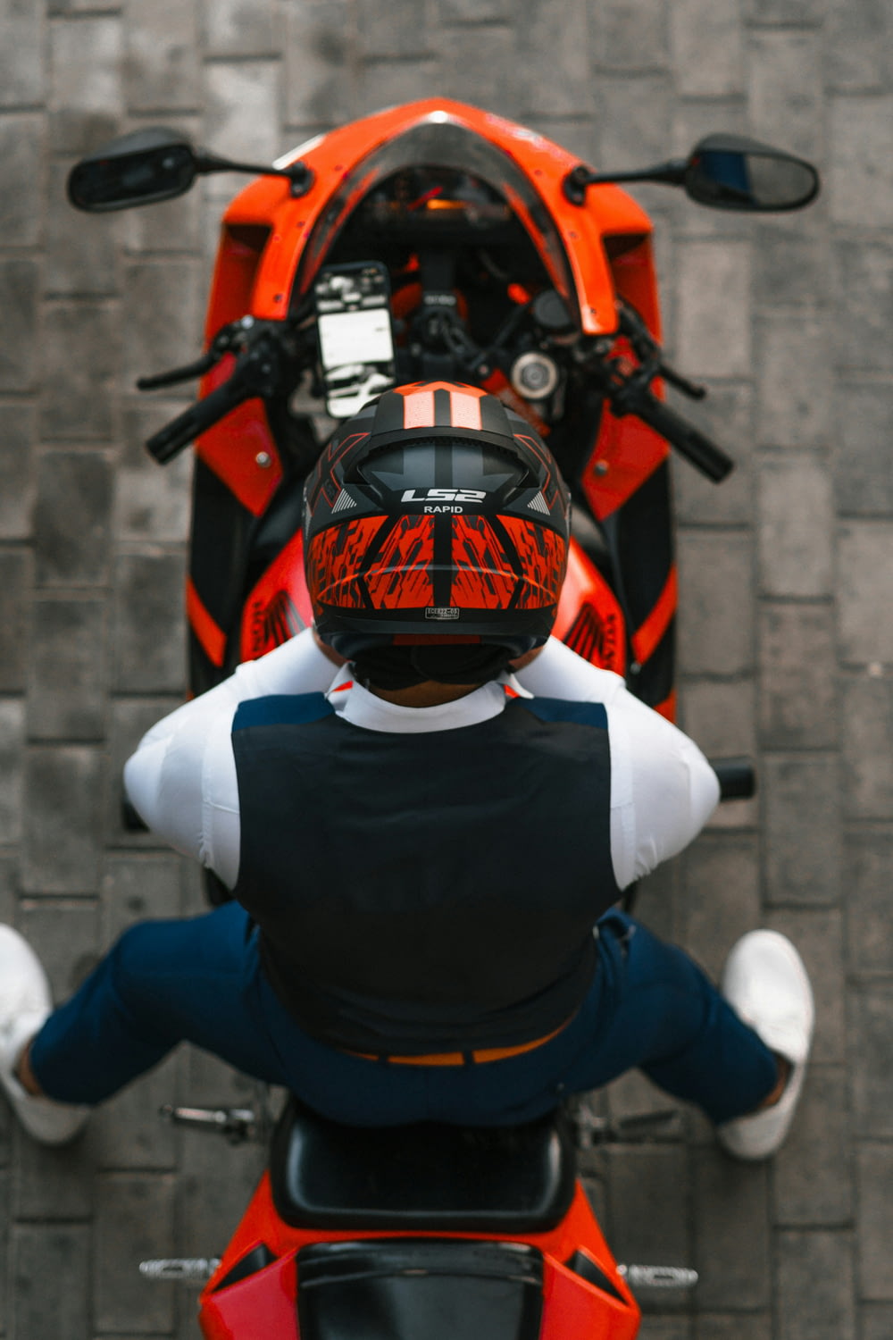 a person wearing a helmet sitting on a motorcycle