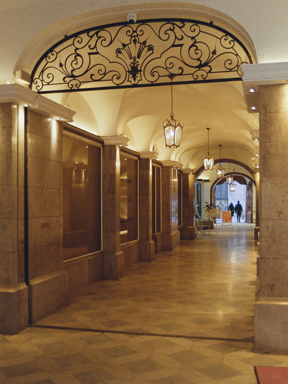 a long hallway with a wrought iron gate