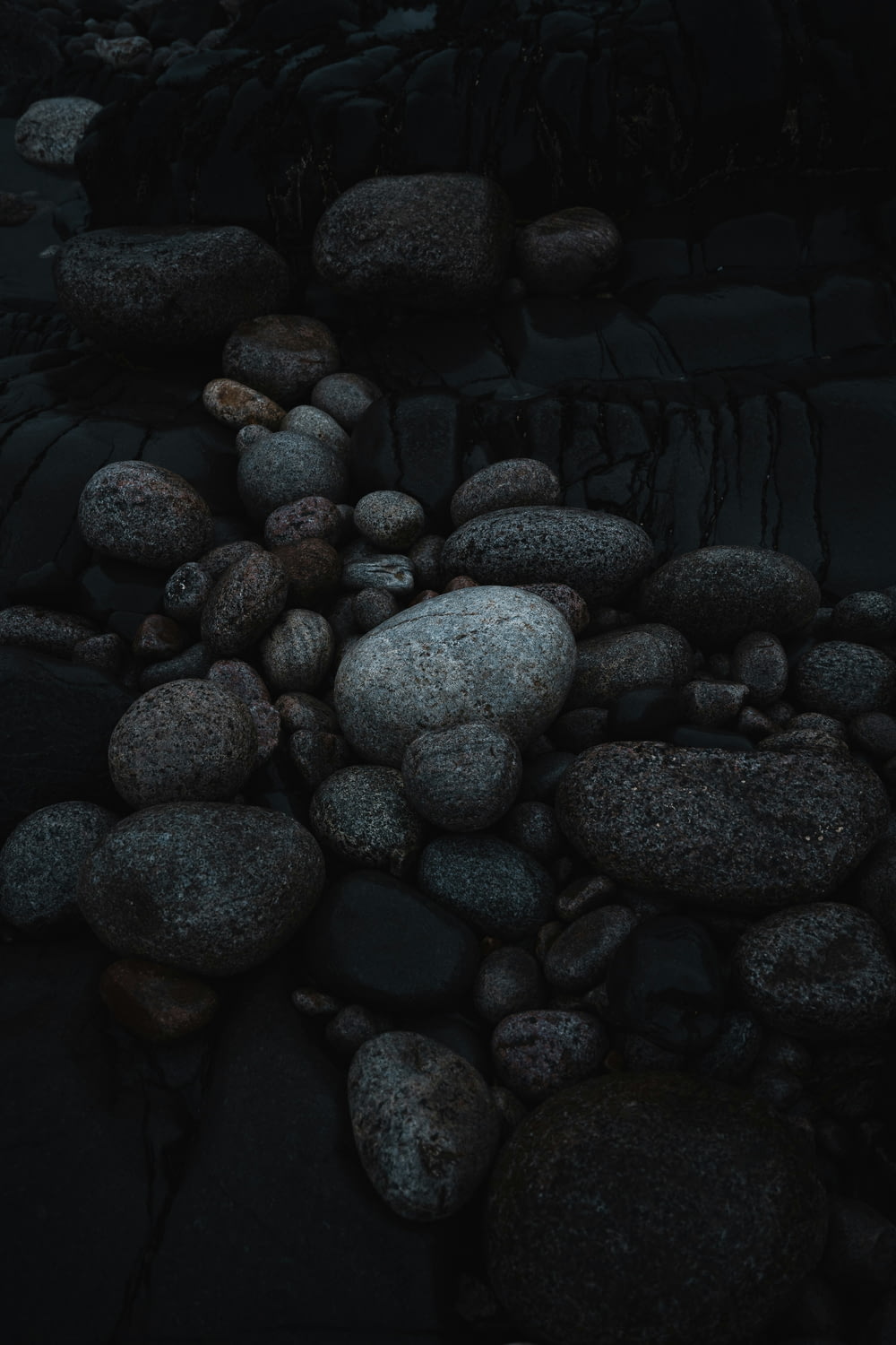 a pile of rocks sitting on top of a beach