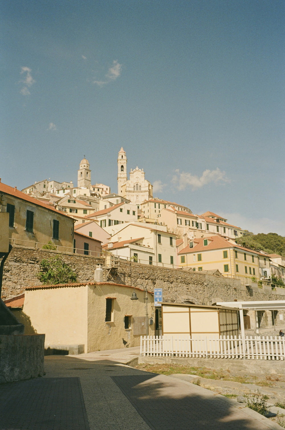 a town with a clock tower on top of a hill