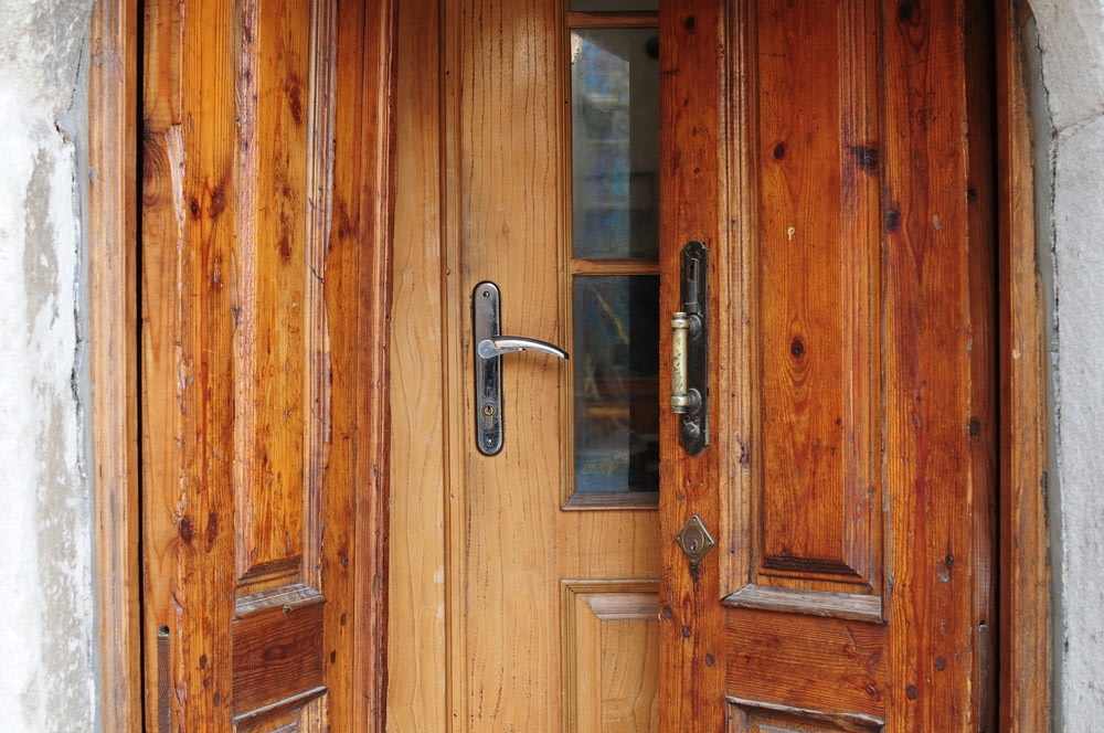 a close up of a wooden door with a handle