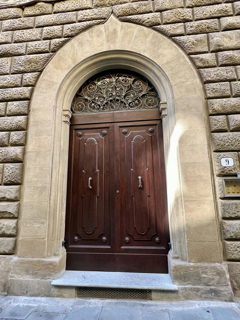 a large wooden door with a window above it