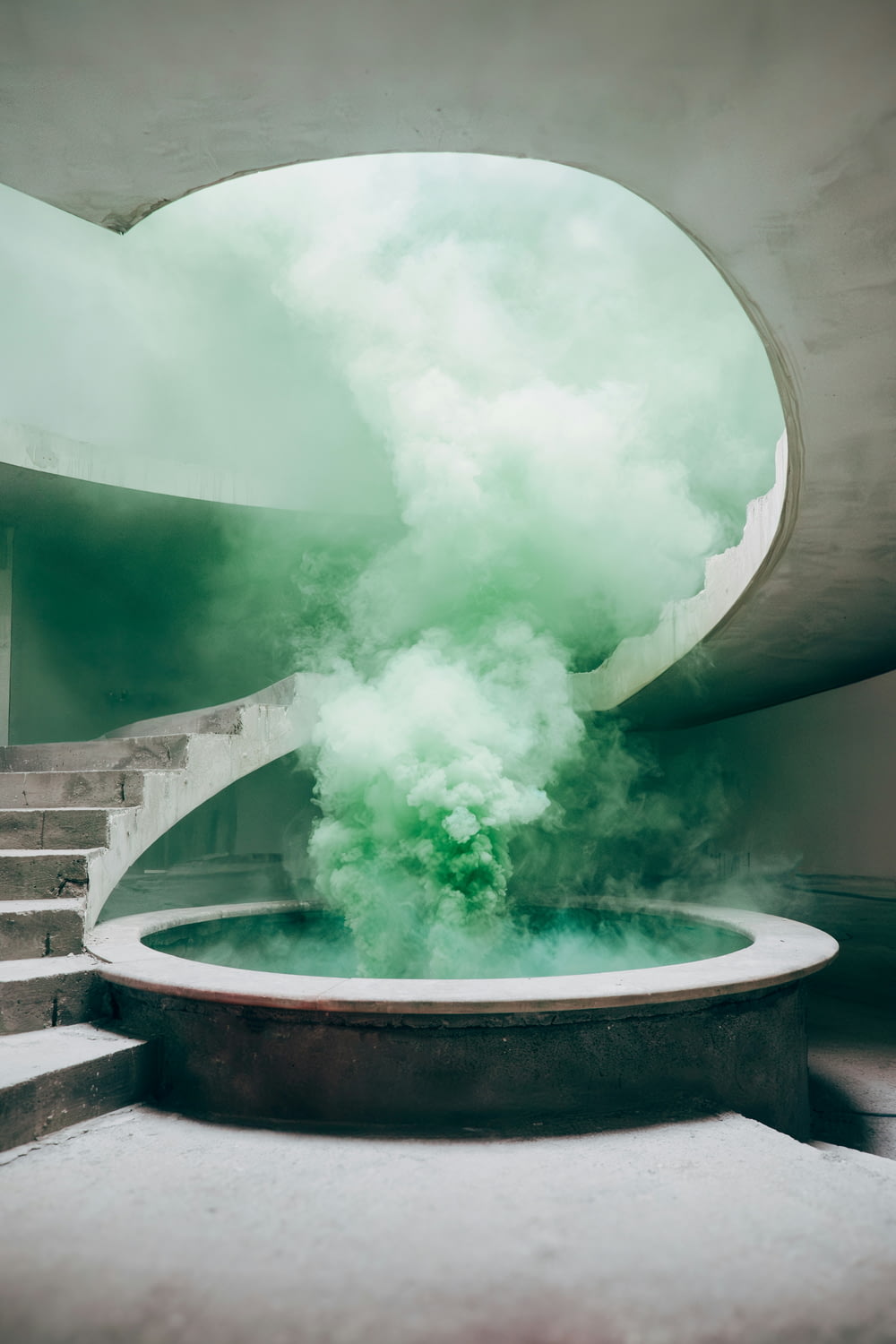 a green smoke bomb is coming out of a fountain