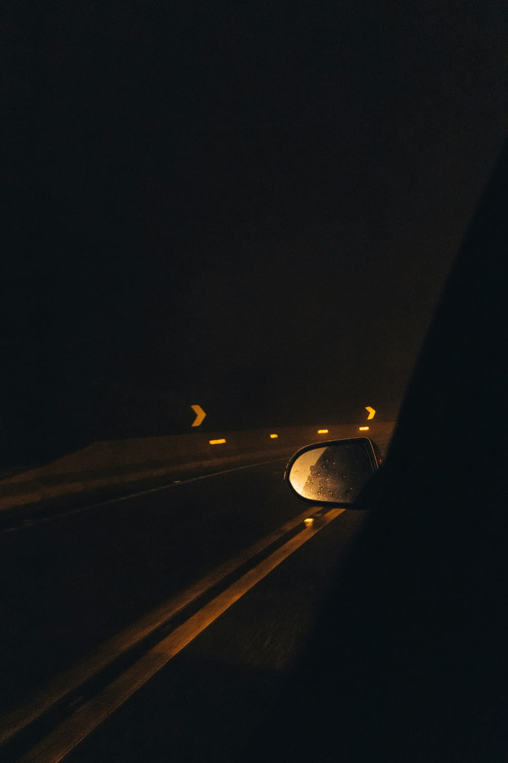 a car driving down a highway at night