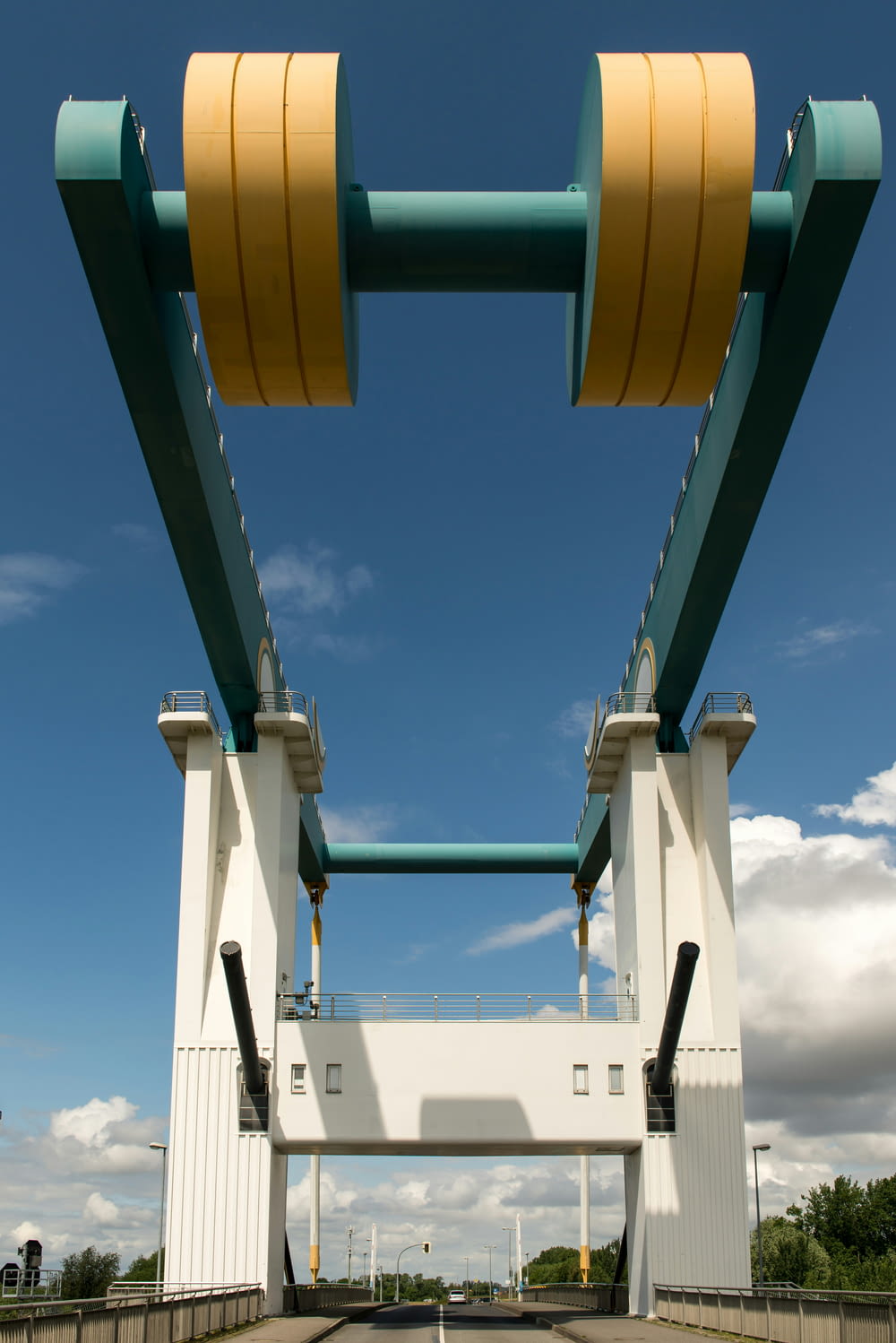 a yellow and green structure with a blue sky in the background