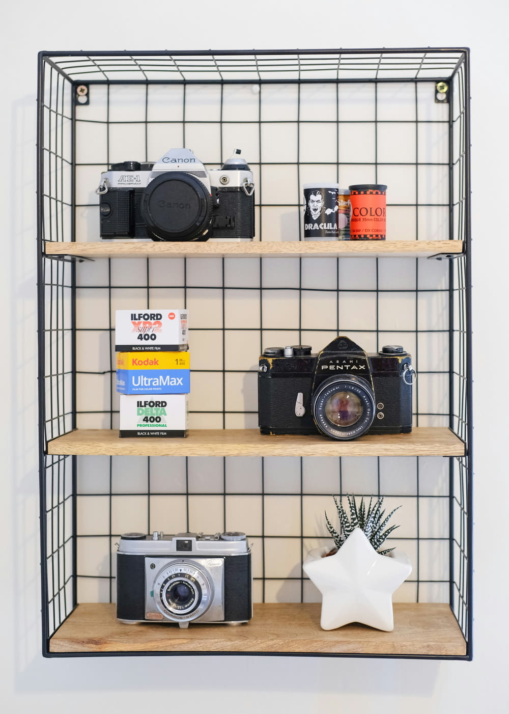 a couple of shelves with cameras on them