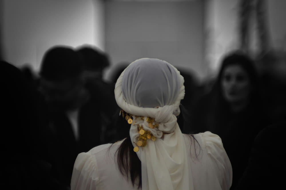 a woman with a white scarf around her head