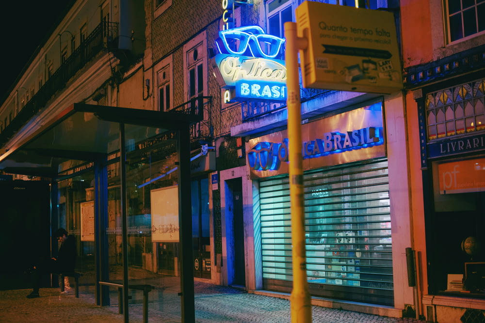 a street corner at night with a neon sign