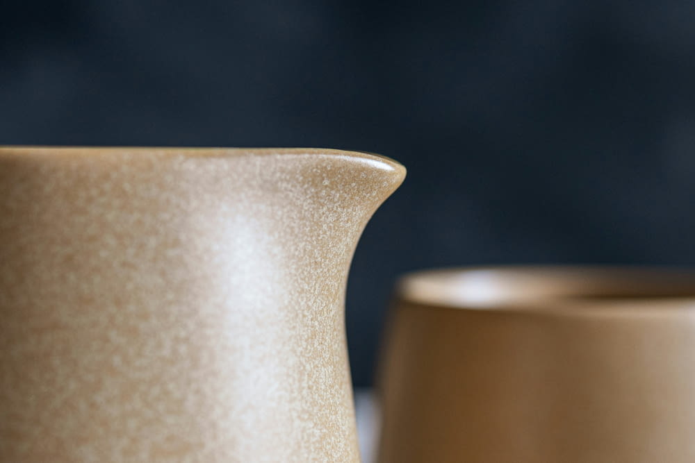 a close up of two vases on a table
