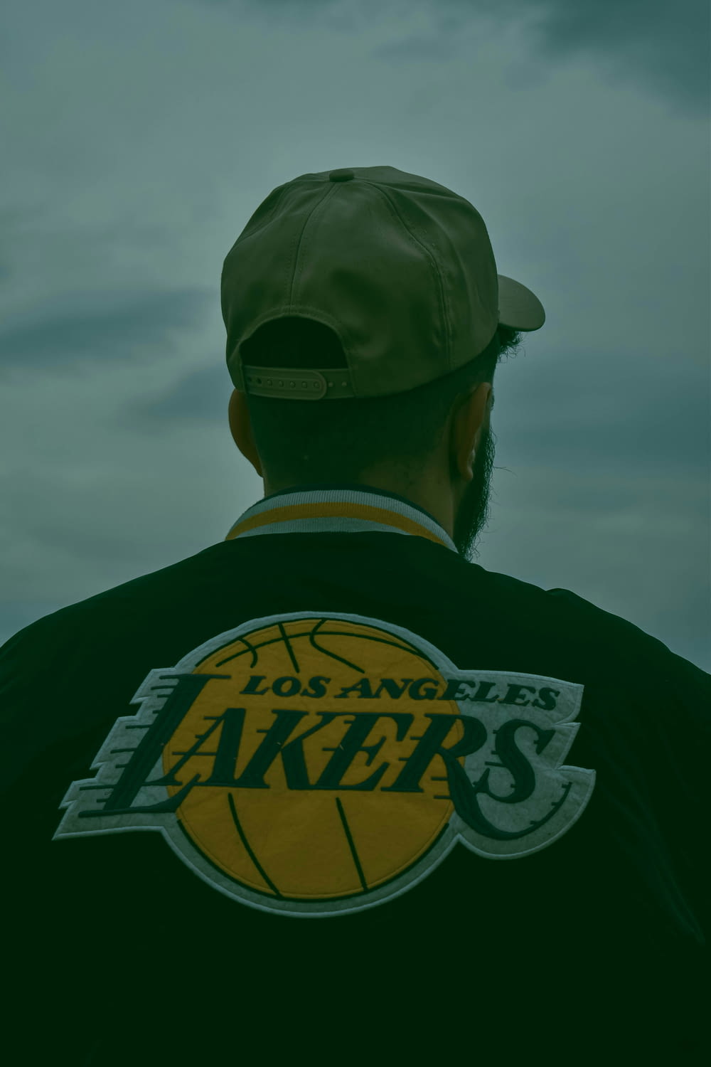 a man wearing a los angeles lakers t - shirt