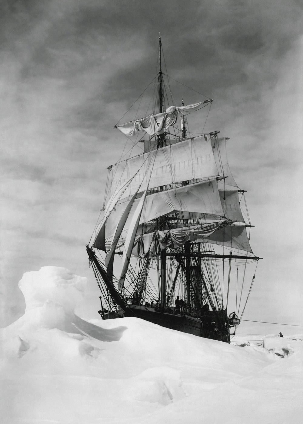 a black and white photo of a ship in the snow