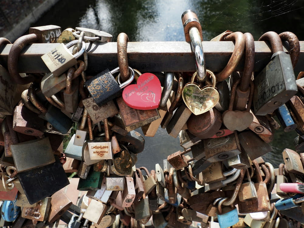 a bunch of padlocks attached to a bridge