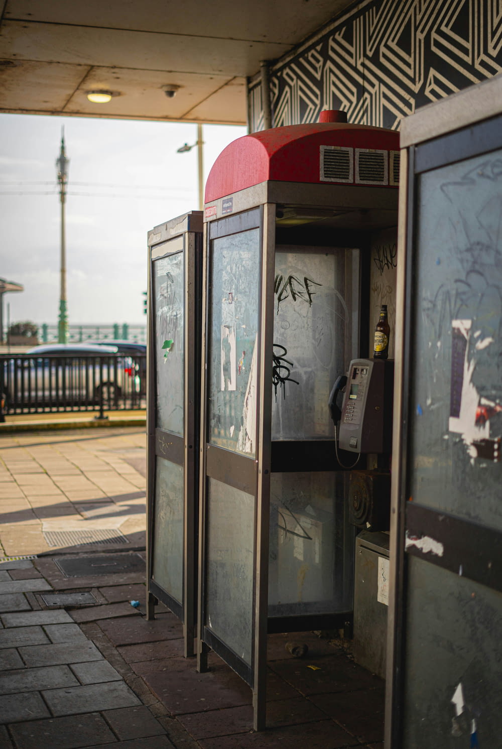 a public phone booth with graffiti on it