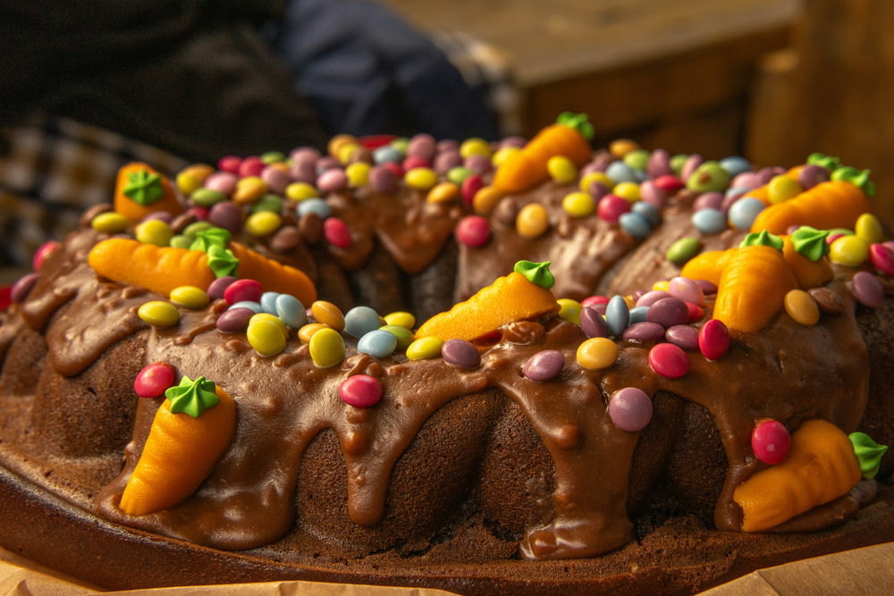 a bundt cake with chocolate frosting and candy toppings