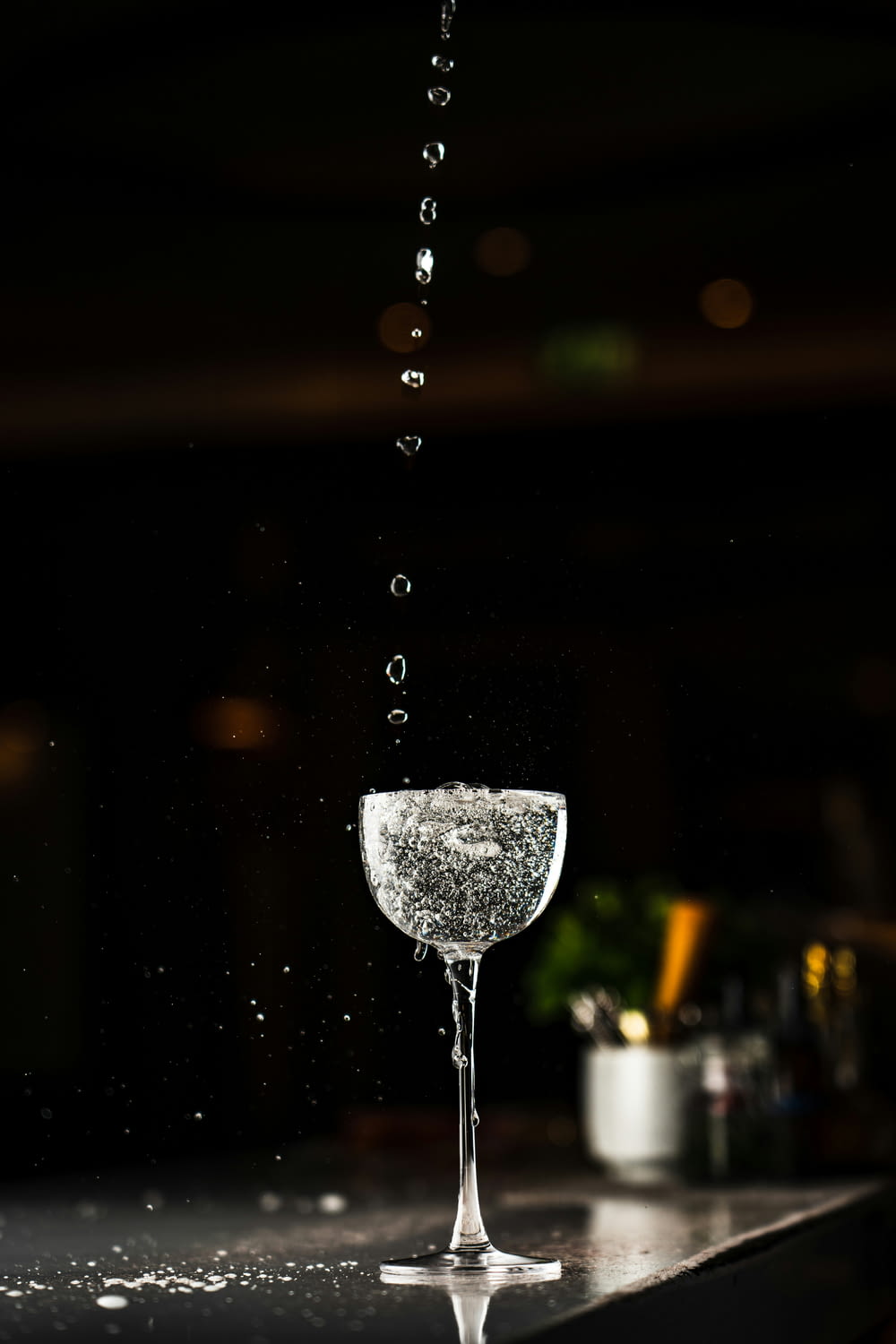 a wine glass with water splashing out of it