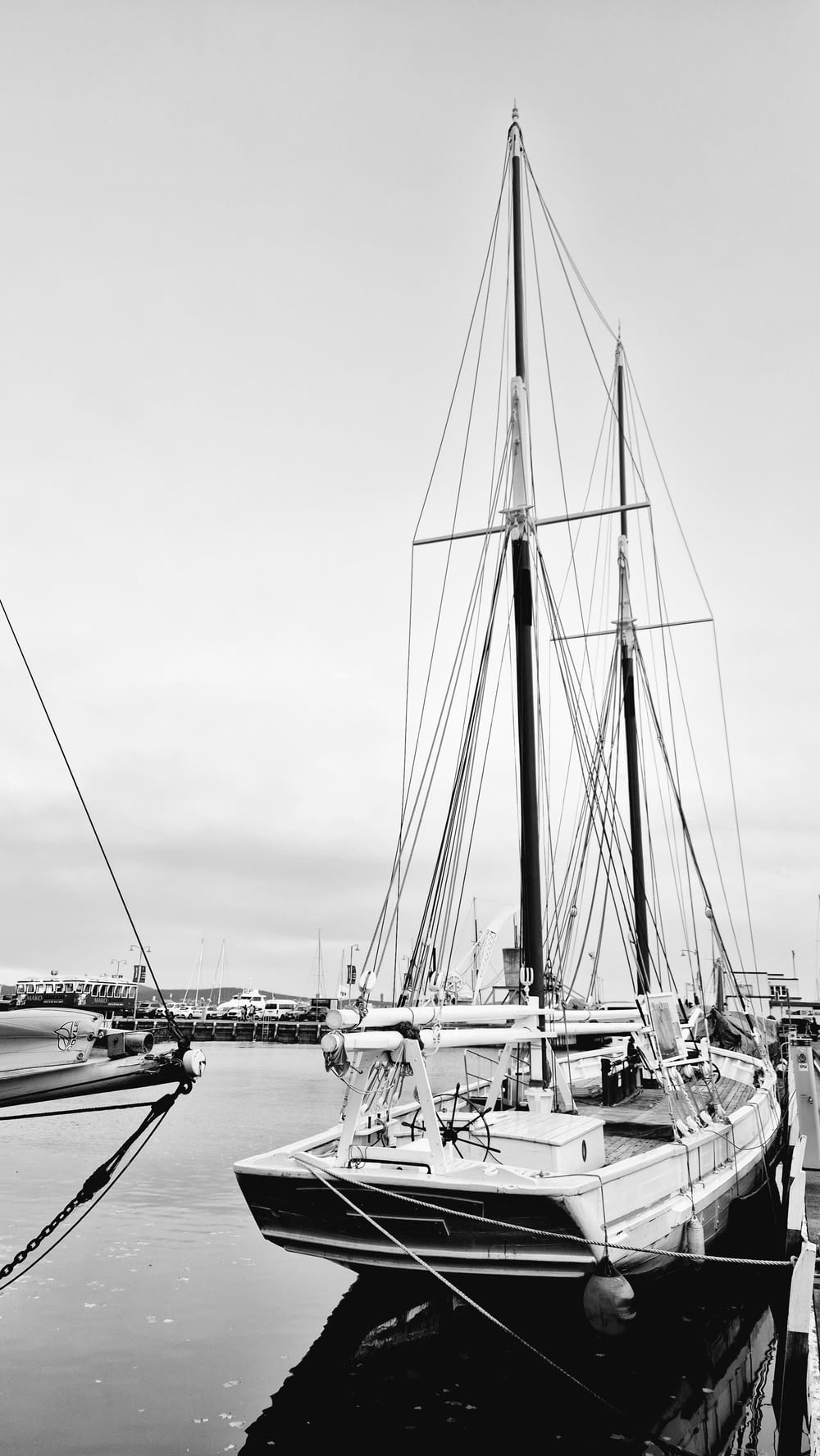 a black and white photo of a sailboat in the water