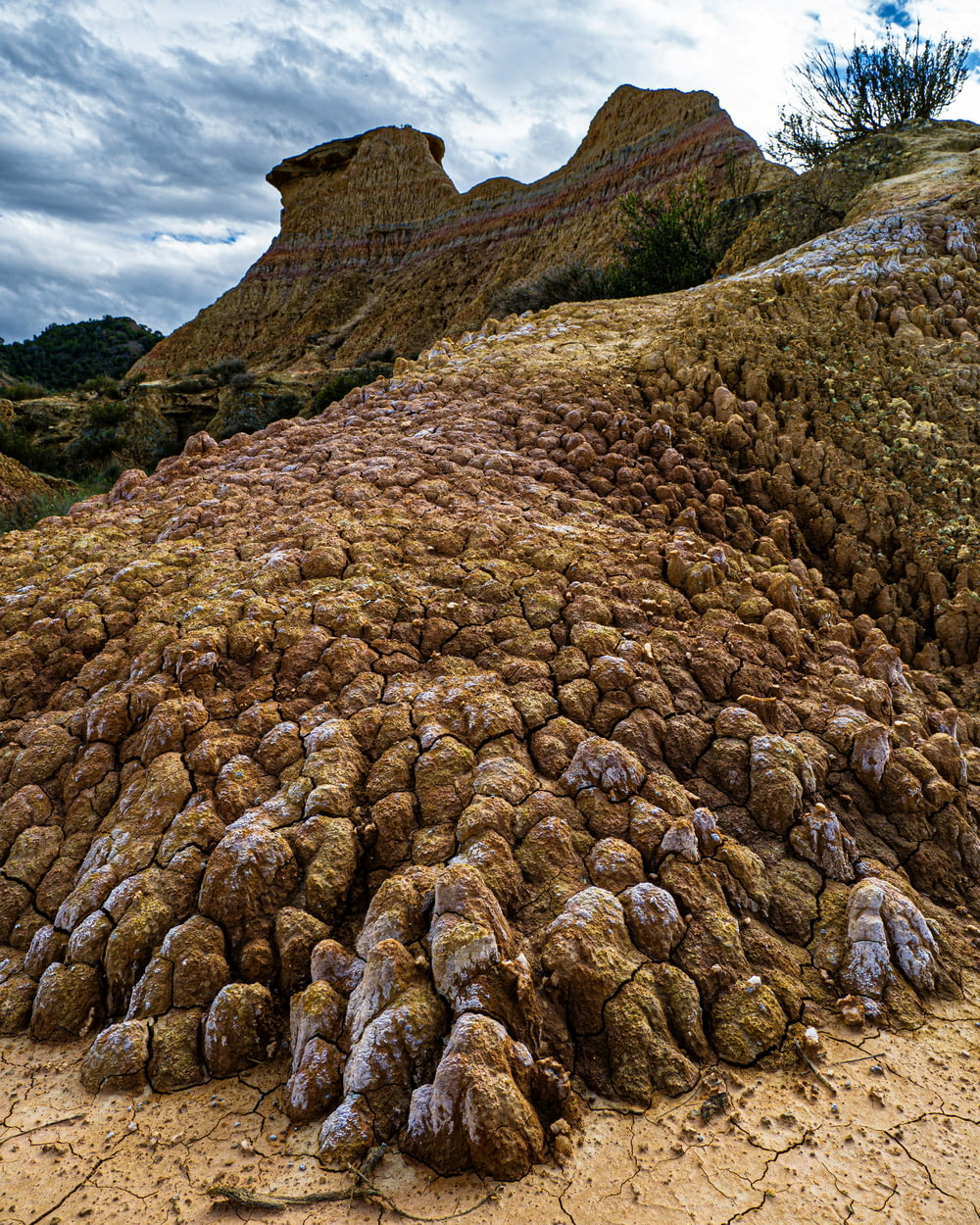 a large pile of rocks sitting on top of a dirt field