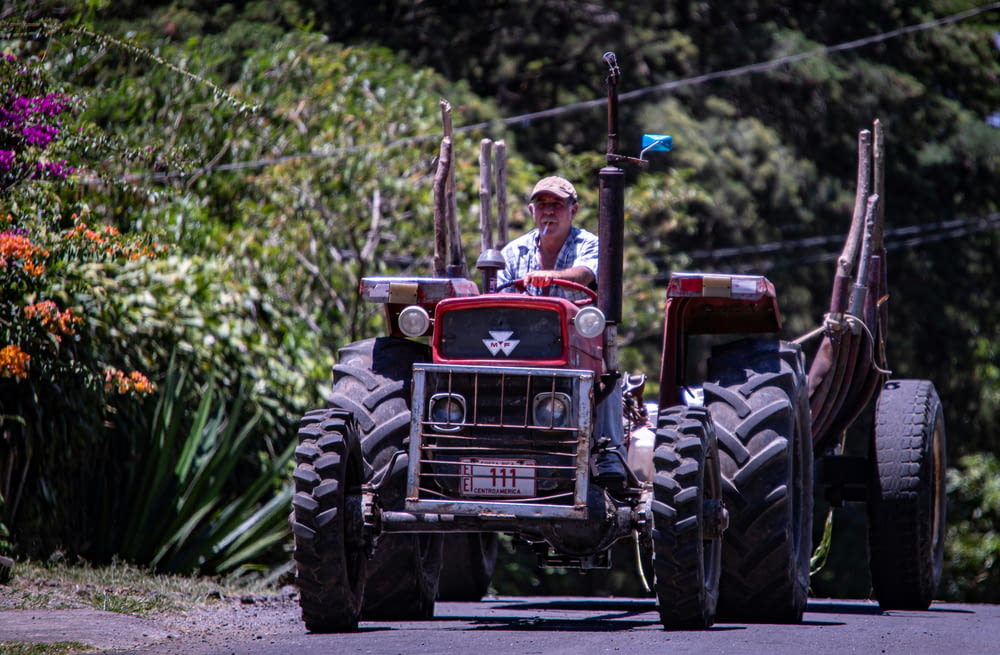 a man driving a tractor down a street