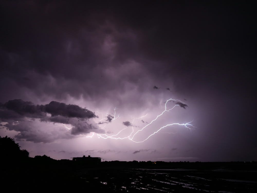 a lightning storm is seen over a city