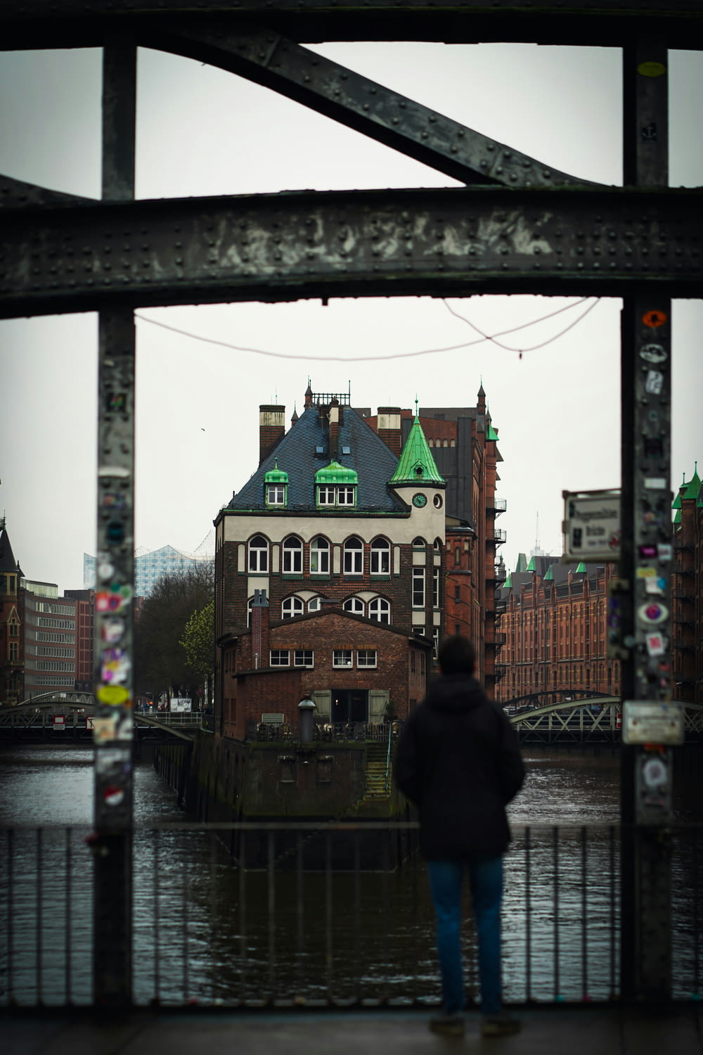 a person standing on a bridge looking at a building