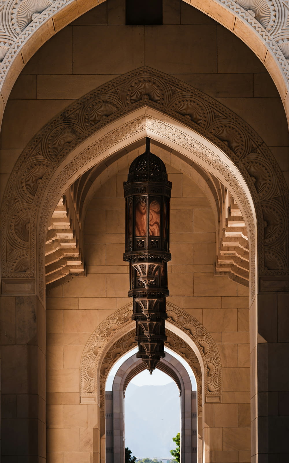 an archway with a clock hanging from it's side