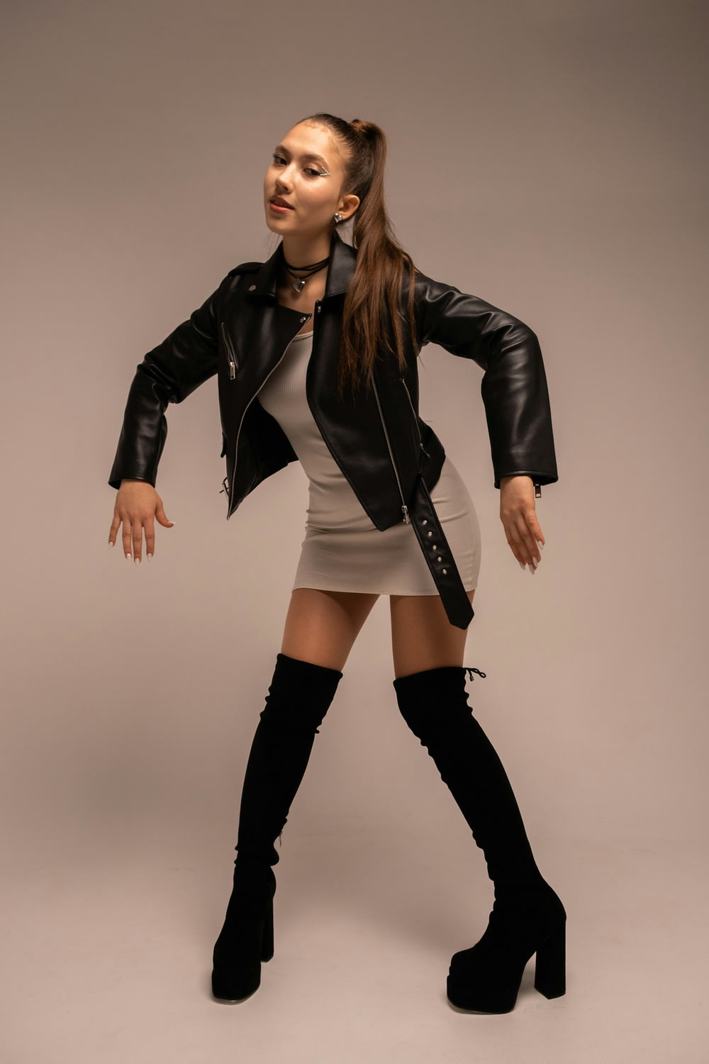 a woman in a short skirt and black jacket