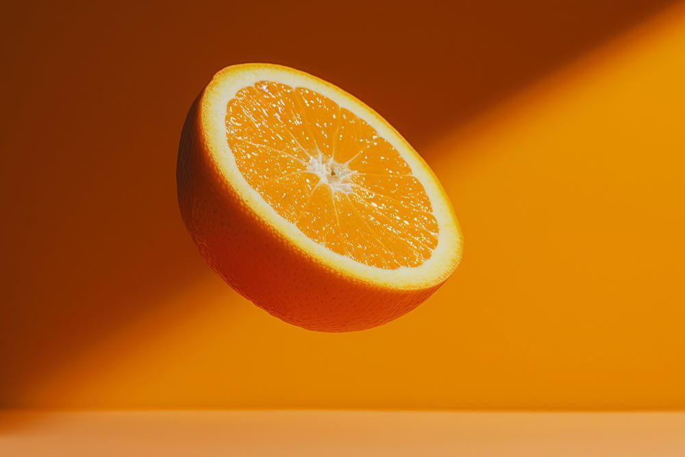 a half of an orange sitting on top of a table