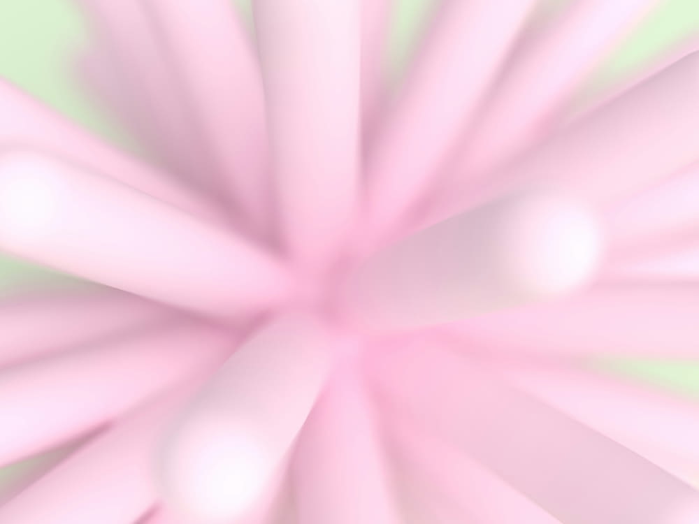 una imagen borrosa de una flor rosa sobre un fondo verde