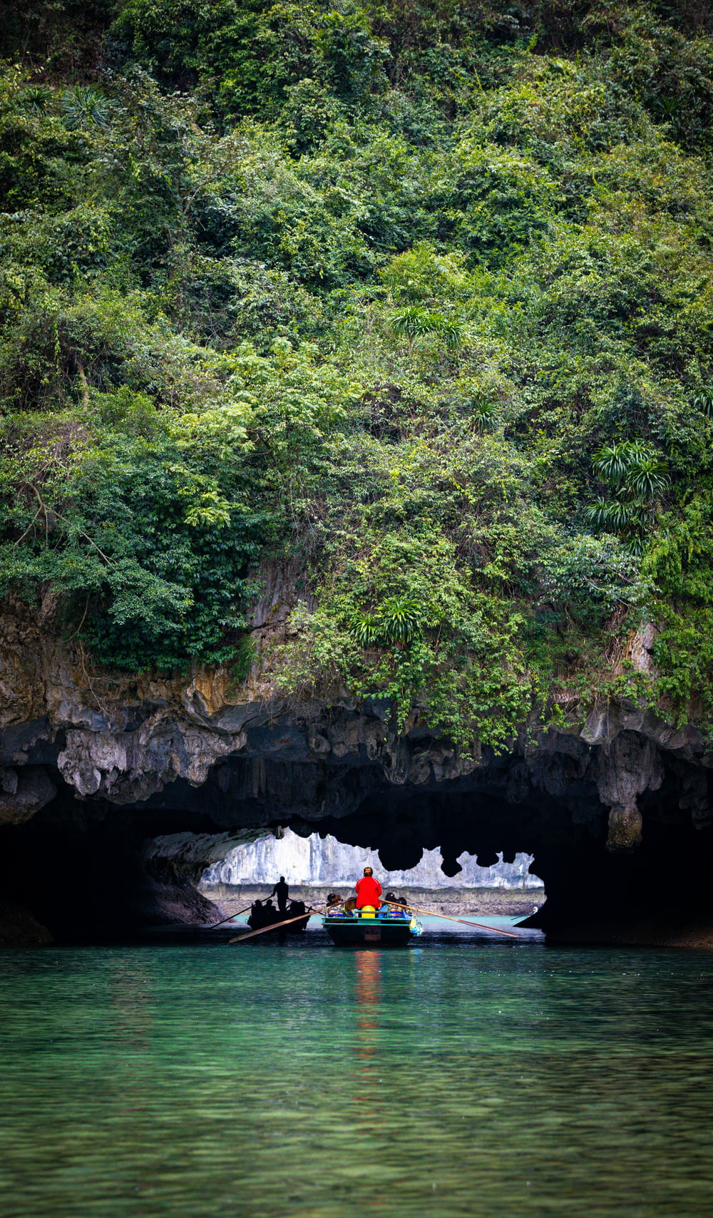 a boat in the water near a cave